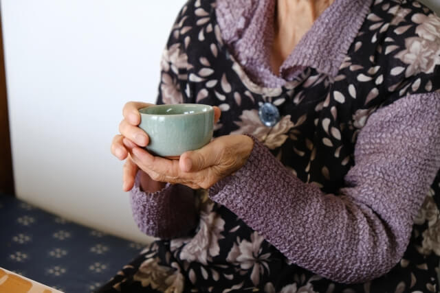 お茶を飲む高齢の女性